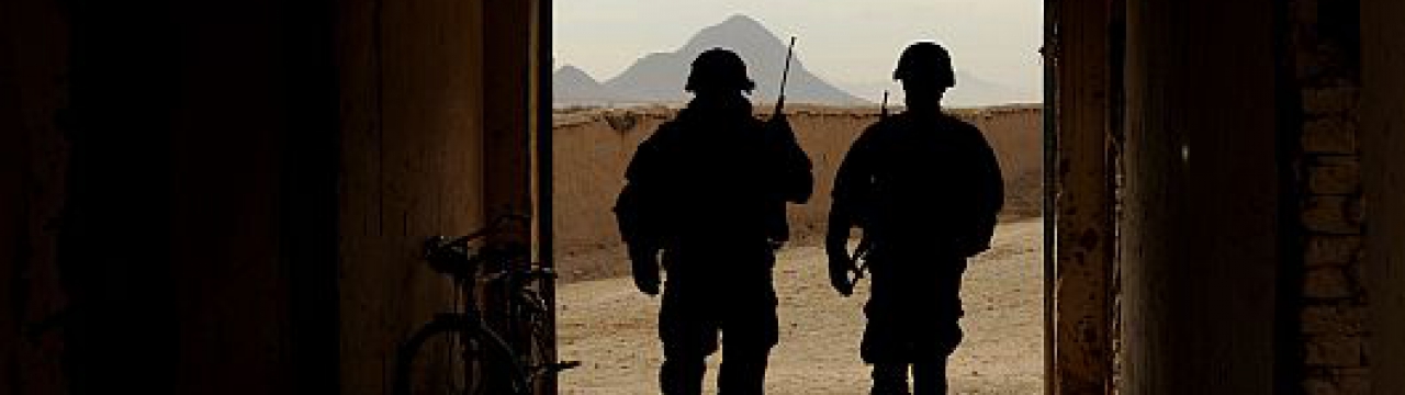 Two US soldiers walking out of a building