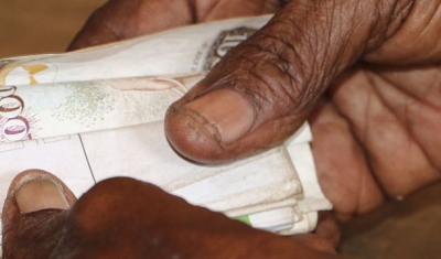 Tana Delta region, Kipao village. Haduko benefits of a cash assistance programme of the ICRC for people affected by the drought. The assistance is sent through a mobile money service, and the receiver then makes a cash withdrawal from a mobile money vendo