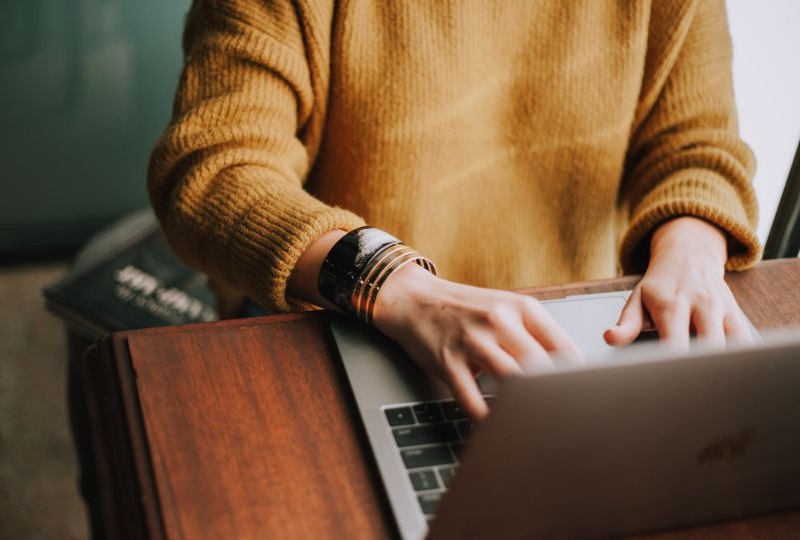 Woman typing on a laptop