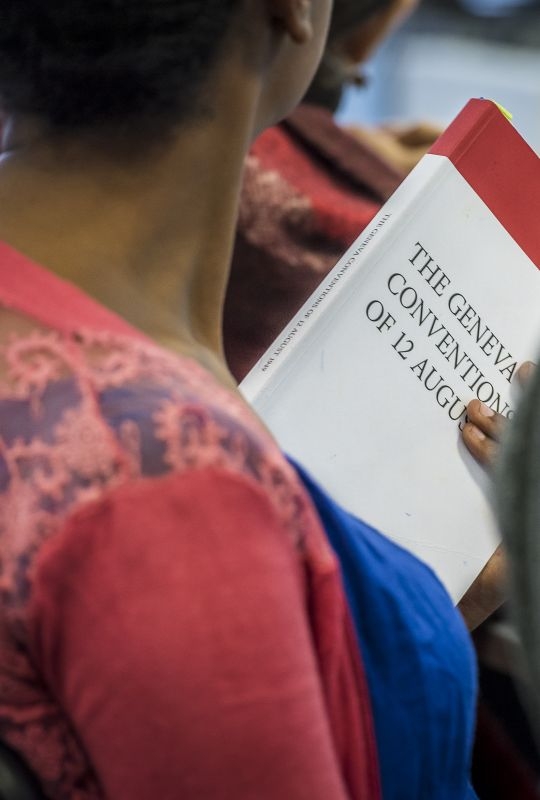 A student holds the Geneva Conventions