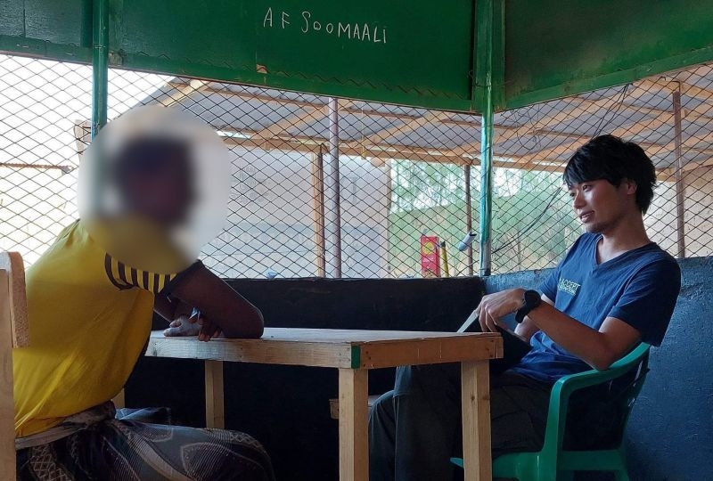 Yosuke Nagai in the field, conducting an interview