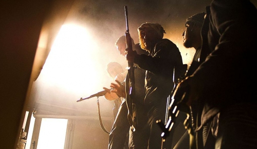 Libya, Misrata, Tripoli Street. Combattants carefully move into a building.