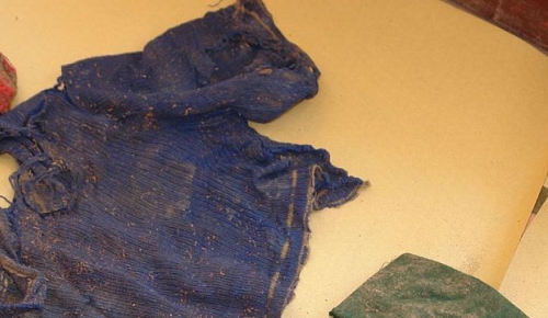 Putis, Peru. The clothes of missing child found in a mass grave close to the village at the exhibition organized for the relatives of victimes. The family will be able to identify their missing relatives.