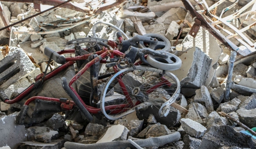 A wheelchair completely destroyed after the bombing of a civilian area